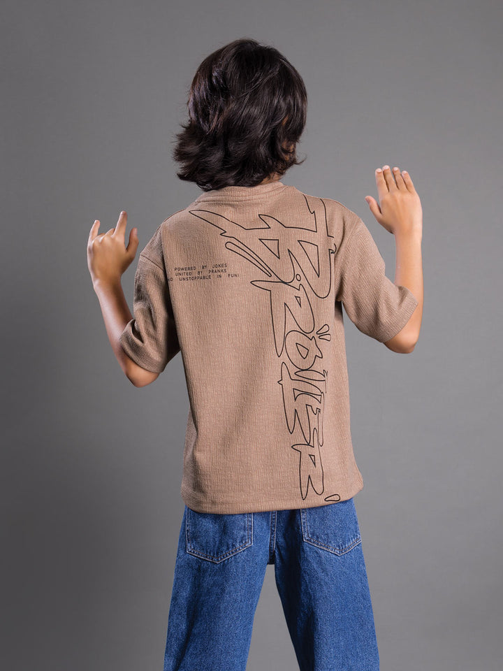Back view of a boys oversized drop shoulder round neck graphic t-shirt