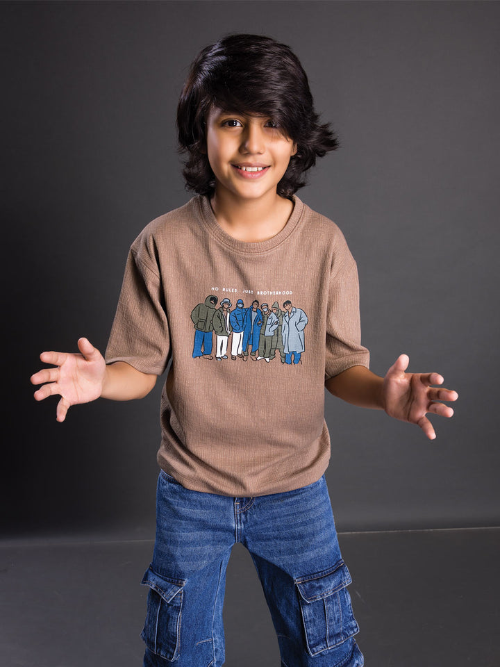 Boy wearing a printed drop shoulder round neck t-shirt with a relaxed fit