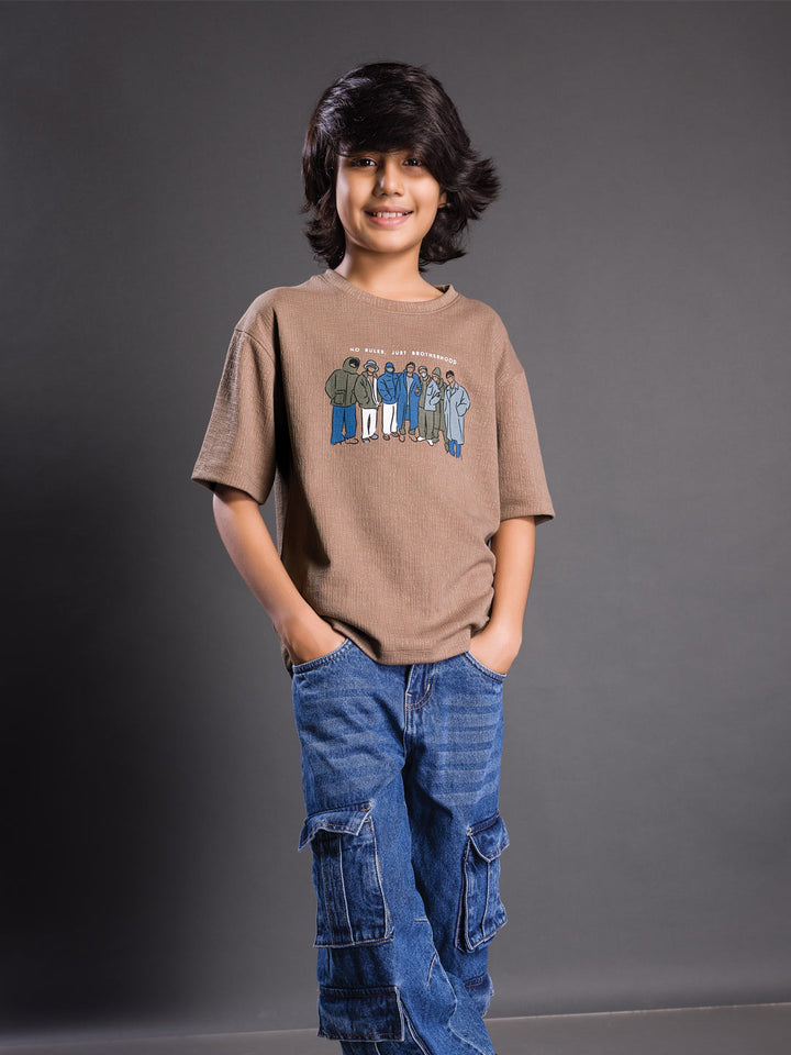 Boy wearing a printed drop shoulder round neck t-shirt with a relaxed fit