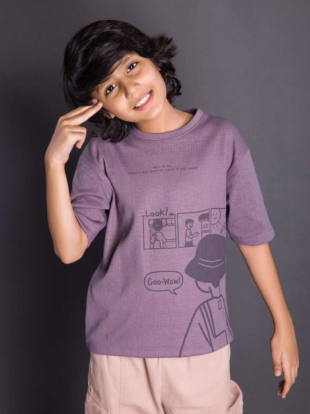 Boy wearing a printed drop shoulder round neck t-shirt with a relaxed fit