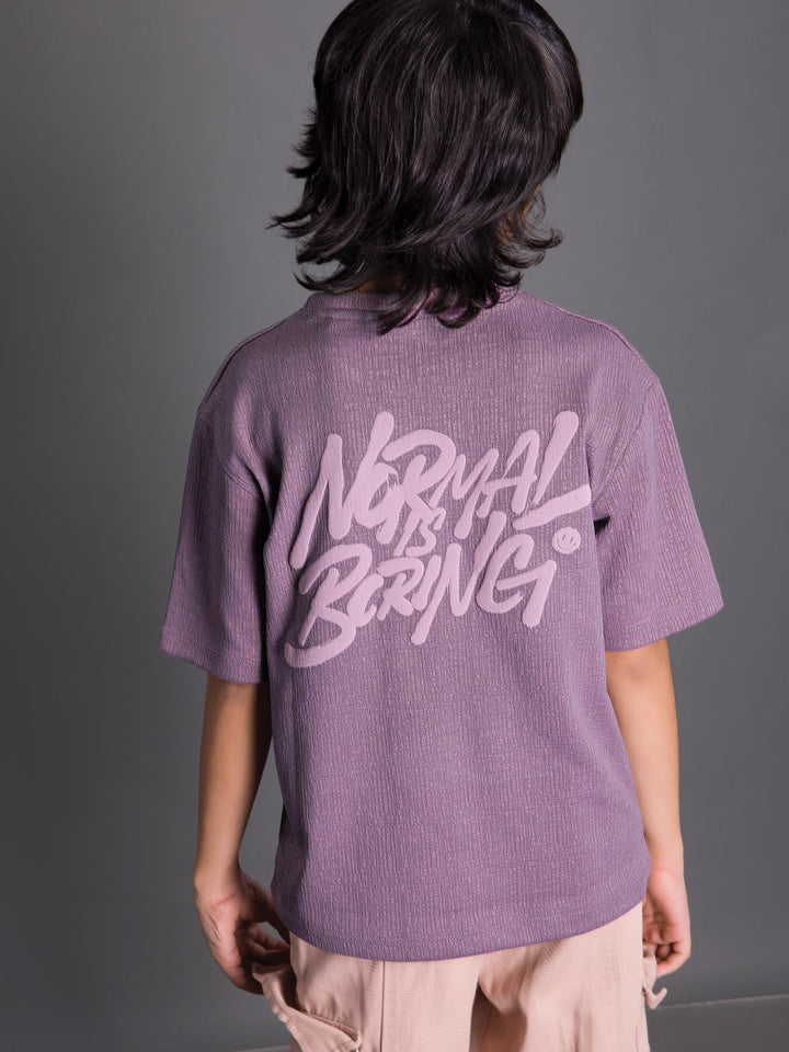 Back view of a boys oversized drop shoulder round neck graphic t-shirt