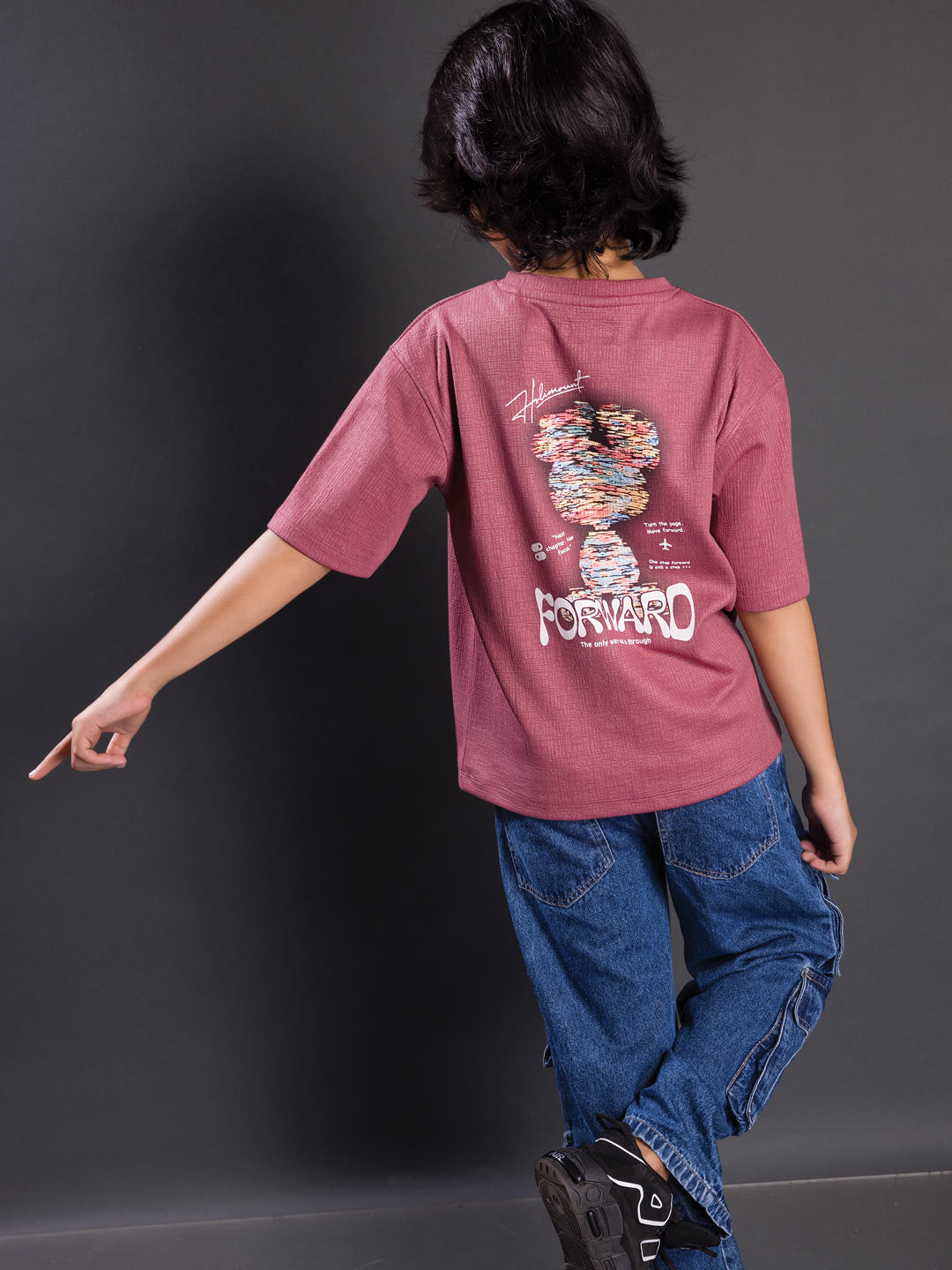 Back view of a boys oversized drop shoulder round neck graphic t-shirt