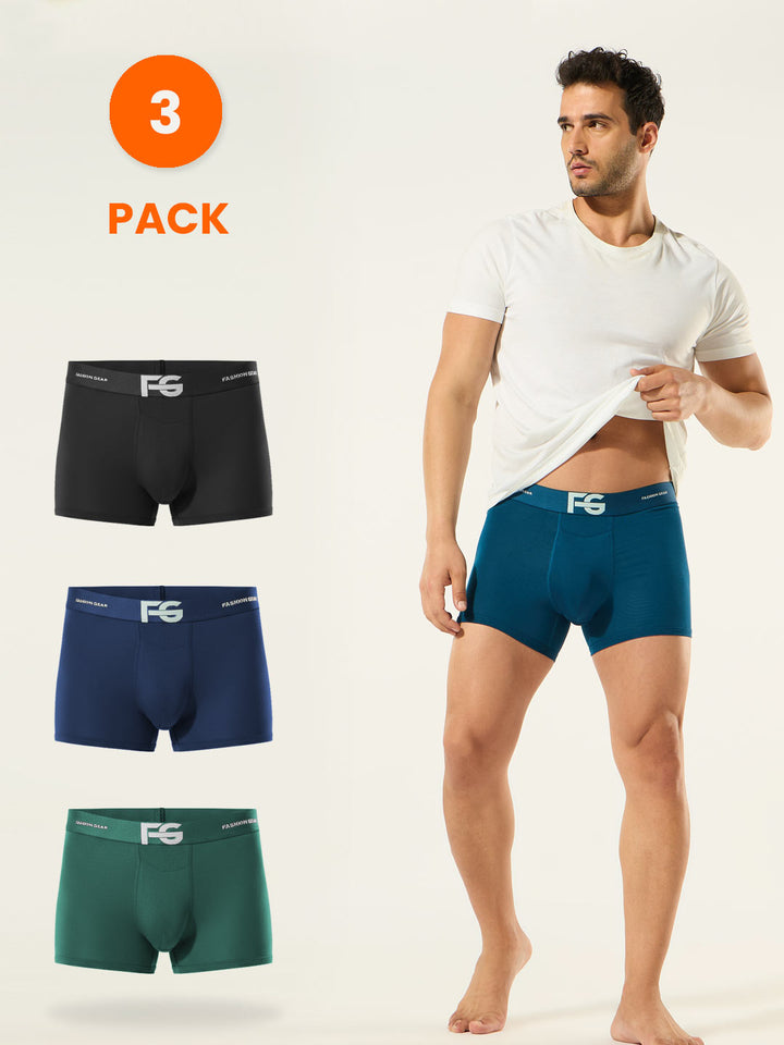 Man wearing a white t-shirt with three pairs of men's underwear displayed below on a light gray background.