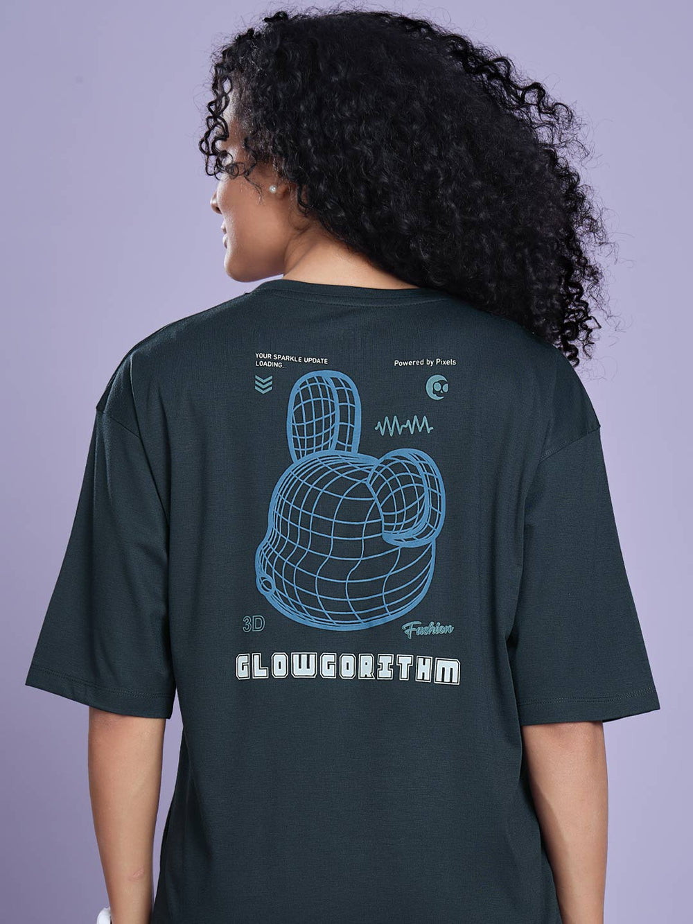 Person wearing a dark green t-shirt with a graphic design on the back against a purple background