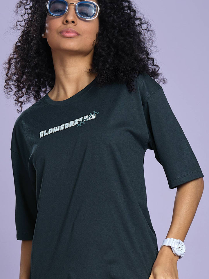 Person wearing a black t-shirt with text on a plain background