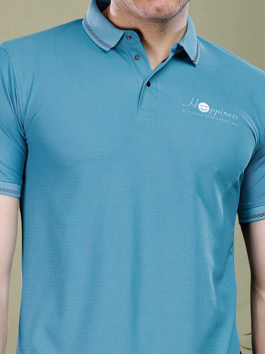 Teal polo shirt with a logo on a neutral background