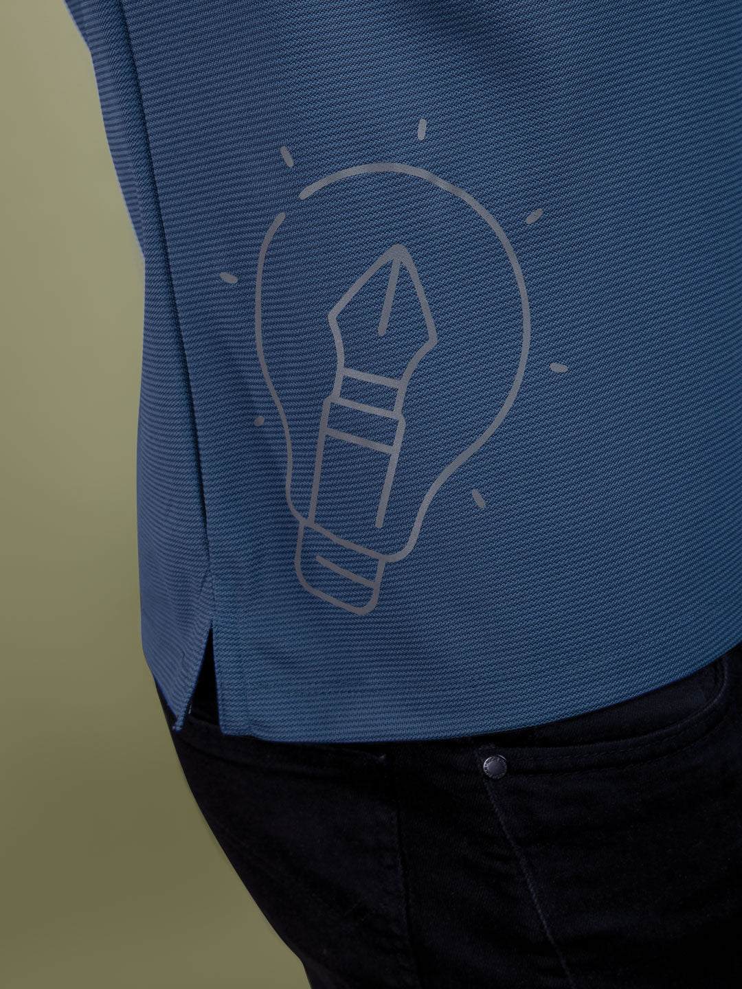 Blue shirt with a light bulb icon on a green background