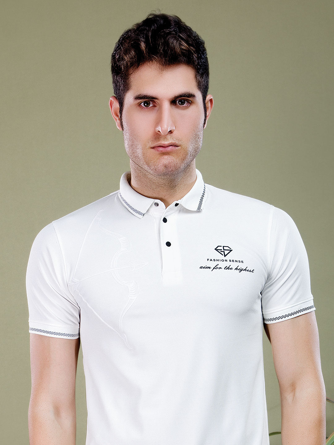 Man wearing a white polo shirt with a logo on a beige background
