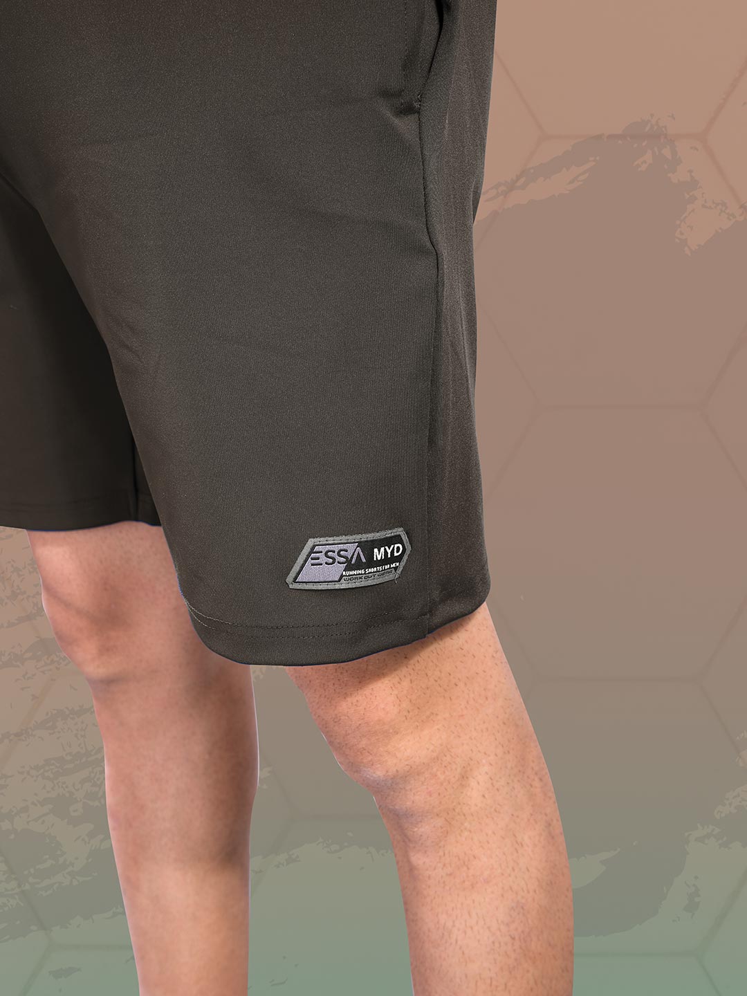 Black shorts with a brand logo on a textured brown background