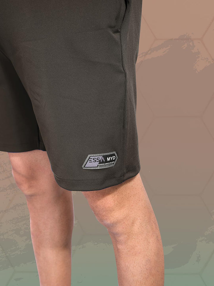 Black shorts with a brand logo on a textured brown background