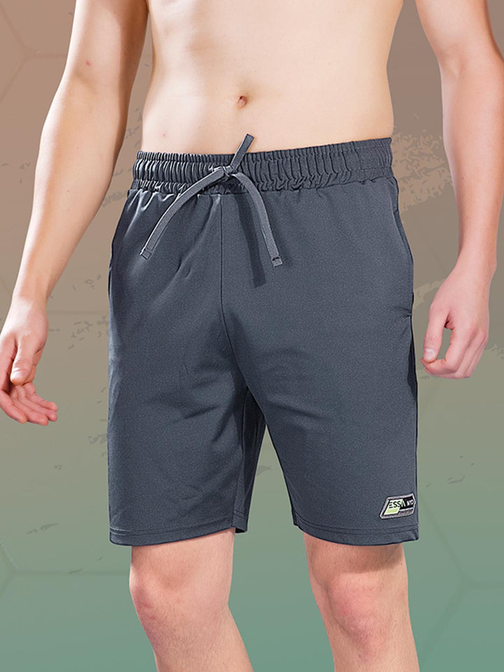 Dark gray shorts with a brand logo on a neutral background