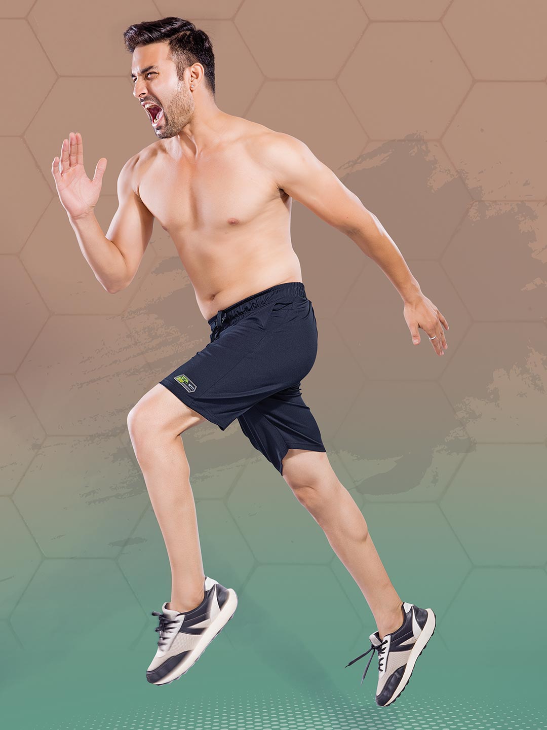 Man in black athletic shorts jumping in front of a gradient background