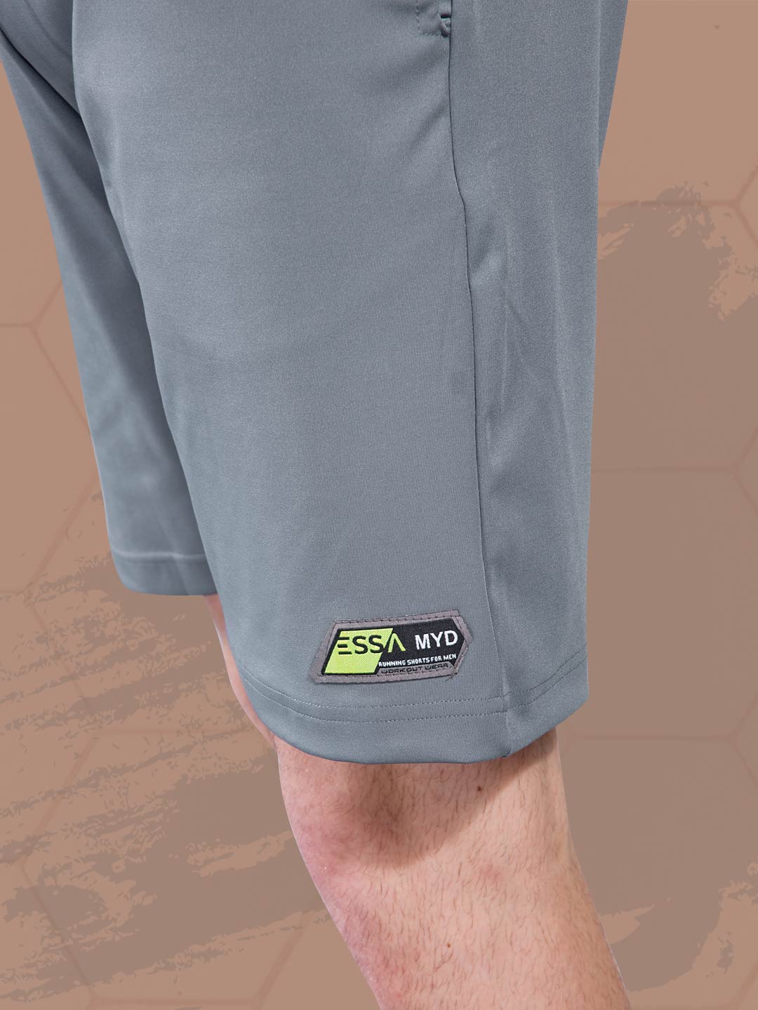 Gray shorts with a visible brand logo on a patterned background
