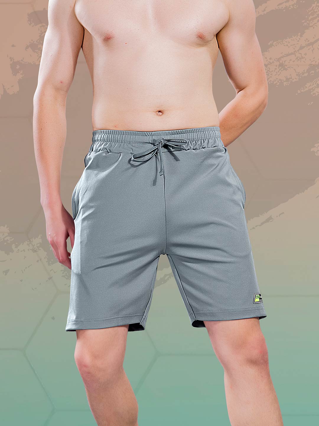 Man wearing gray shorts on a gradient background