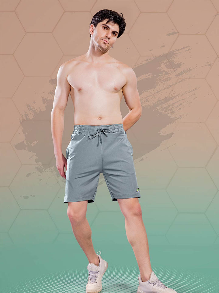 Man wearing gray shorts on a gradient background