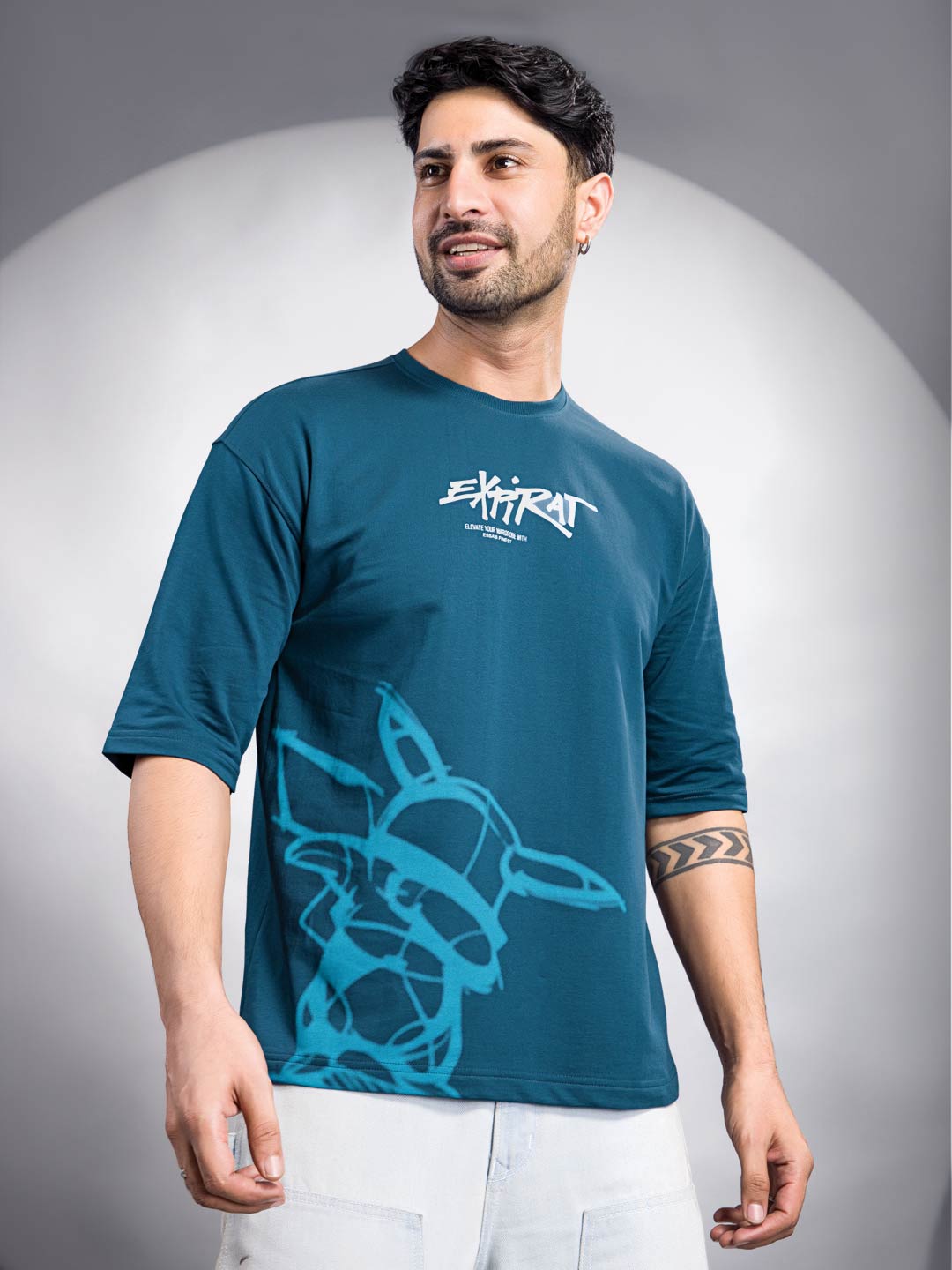 Man wearing a blue t-shirt with a graphic design and text on a gray background