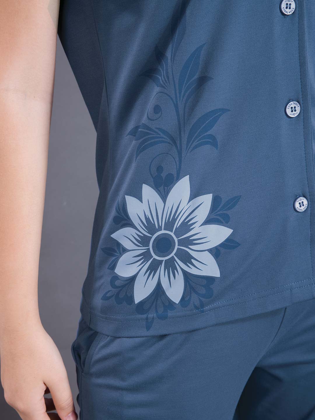 Blue shirt with floral design on a gray background