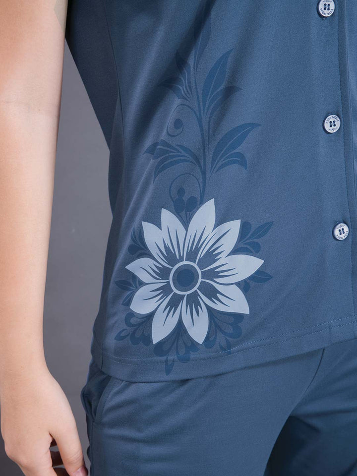 Blue shirt with floral design on a gray background