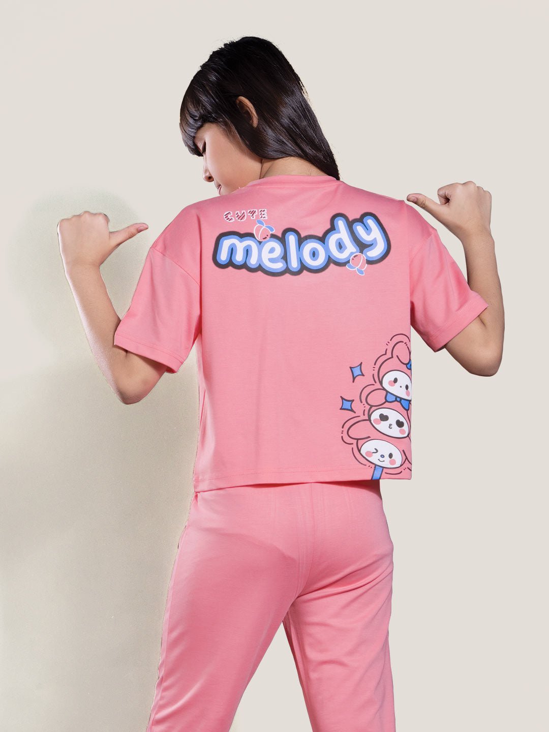 Person wearing a pink outfit with 'melody' branding on the back.