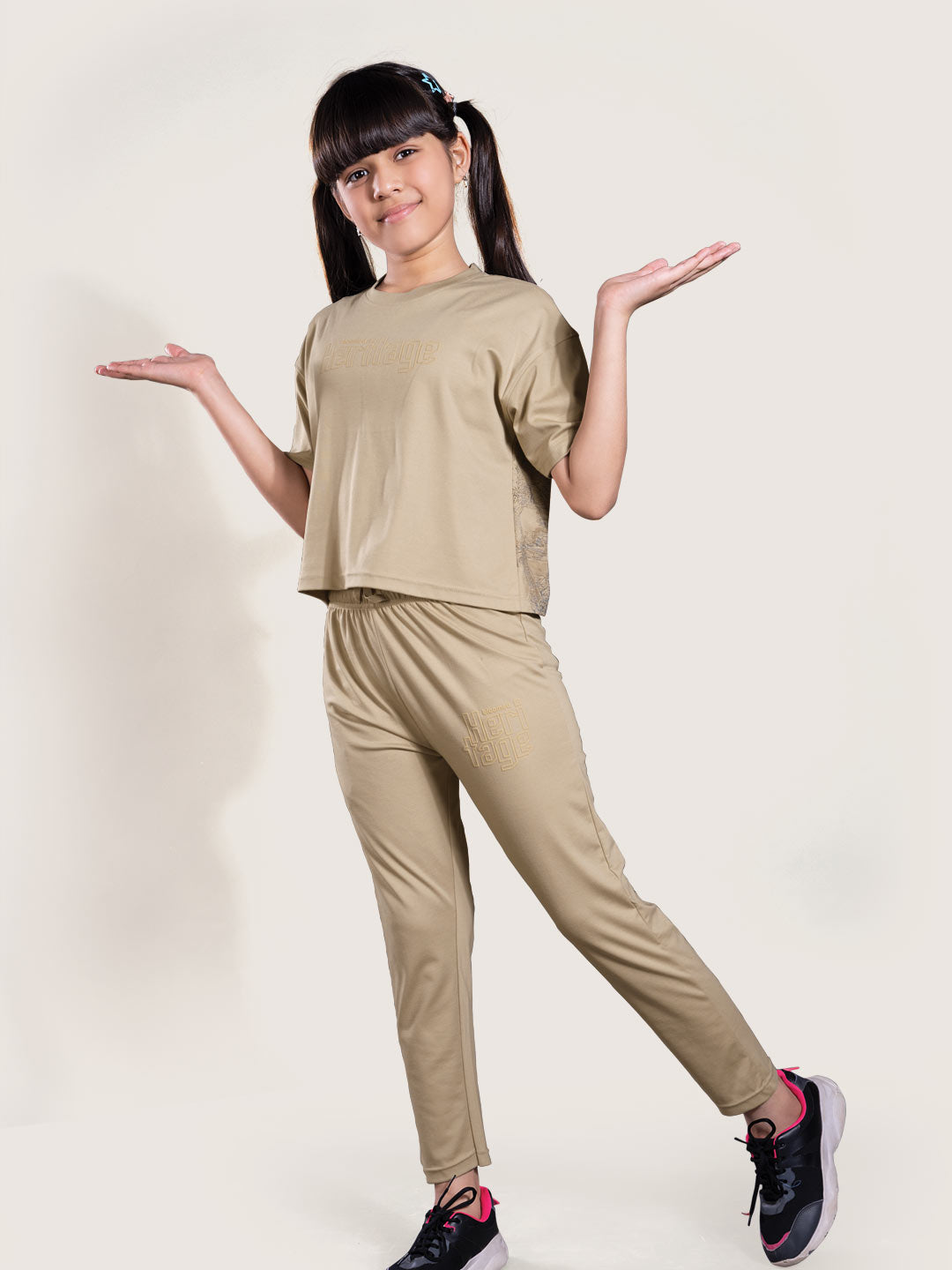 Person wearing a beige outfit on a white background