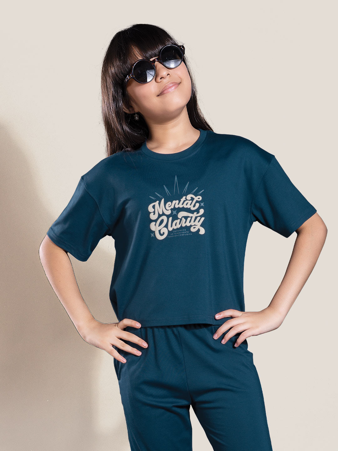 Person wearing a navy blue t-shirt with 'Mental Clarity' text on a beige background