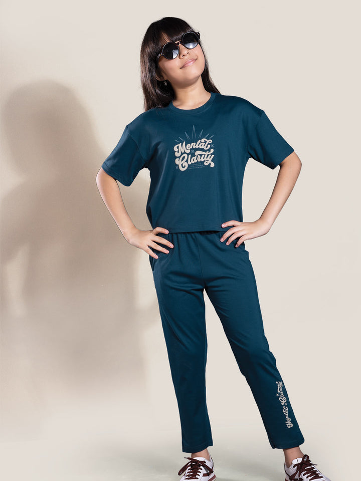 Person wearing a blue outfit with text on a plain background