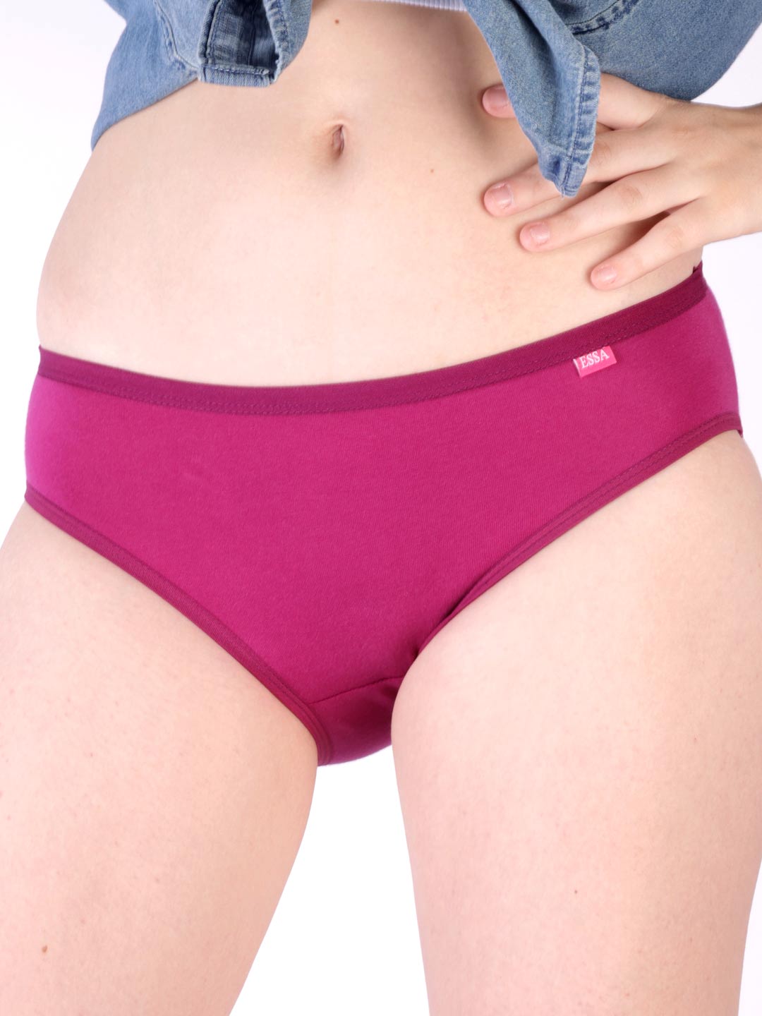 Person wearing a pair of magenta underwear with a brand logo on a white background livana plain outerelastic panties for women #color_dogwood-rose