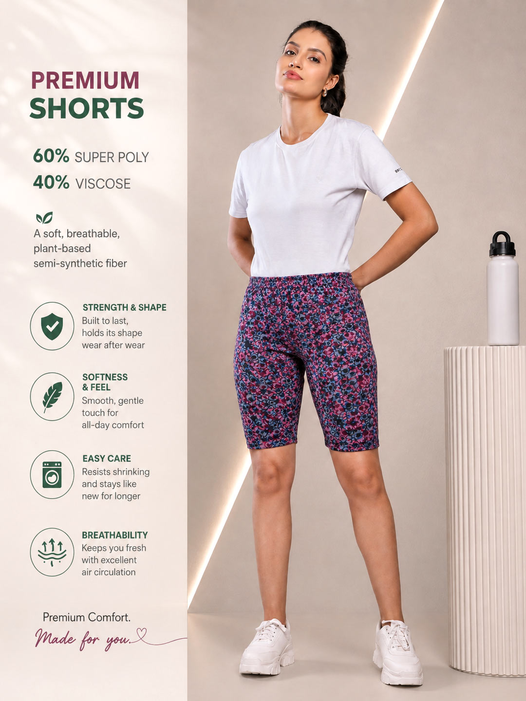 A woman modeling patterned athletic shorts in a studio setting, wearing a white t-shirt and white sneakers. The image features promotional text on the left highlighting the product's 60% super poly and 40% viscoce composition, along with feature icons for strength, softness, and breathability.