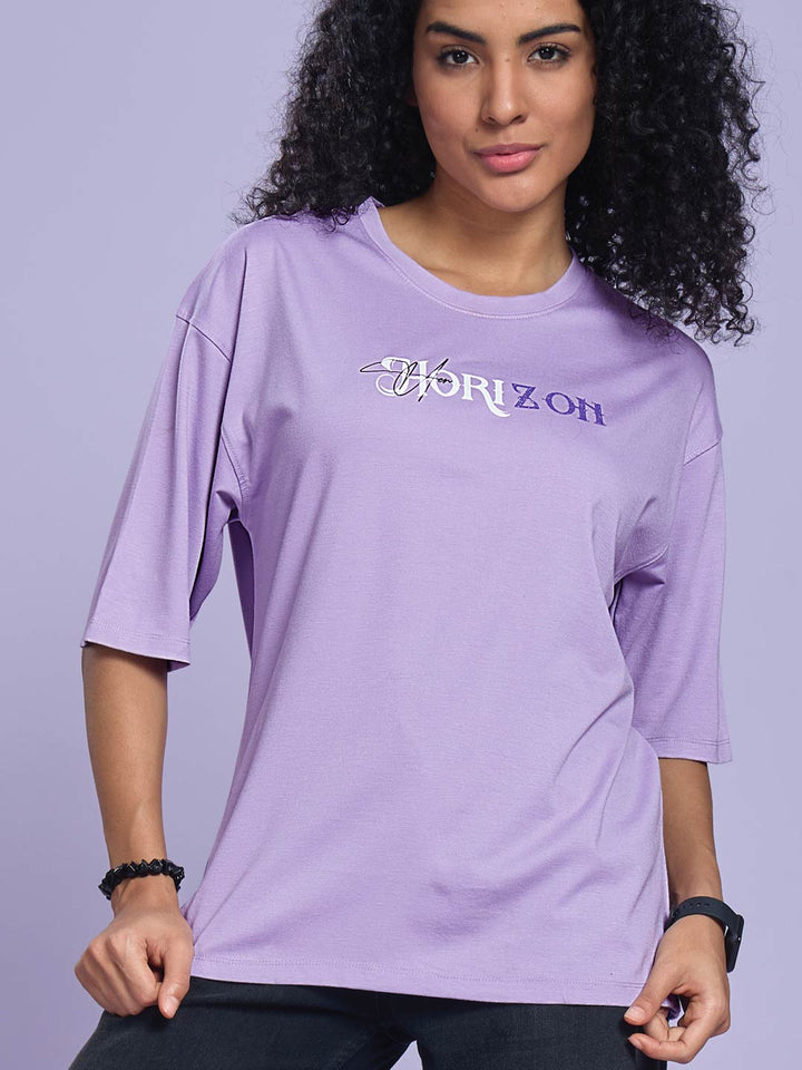 Woman wearing a purple t-shirt with 'Horizon' logo against a light purple background